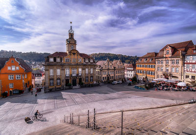 Street amidst buildings in town against sky