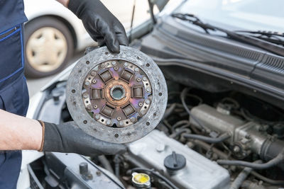 Close-up of man working in car