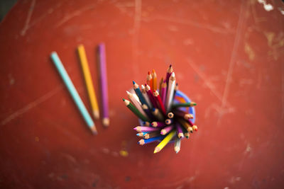 Close-up of colorful pencils in container on table