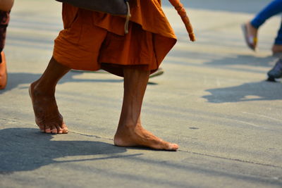 Low section of people walking on street