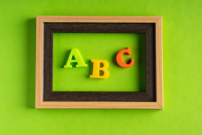 Close-up of toys over green background