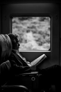 Rear view of man sitting in train