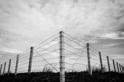 Fence on field against sky