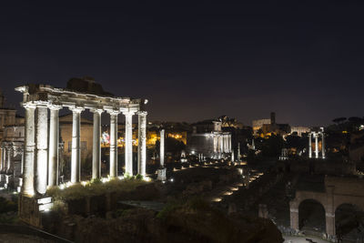 Illuminated city against sky at night