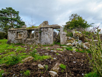 Old ruin on field against sky