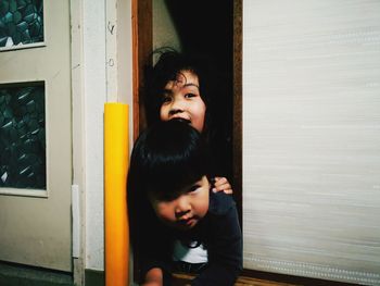 Portrait of boy and girl crawling on floor