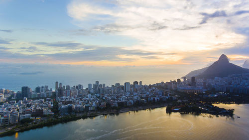 View of city at waterfront during sunset