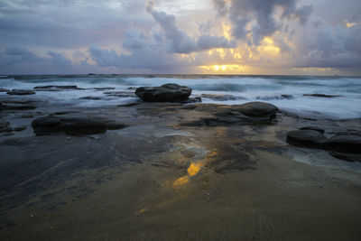 Scenic view of beach at sunset