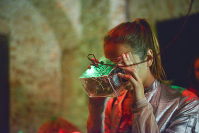 Woman holding electrical equipment