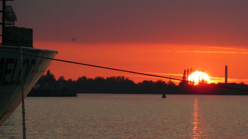 Scenic view of sea against romantic sky at sunset