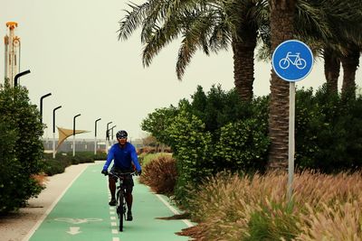 Front view of person cycling on sports track against clear sky