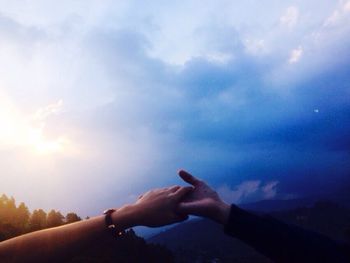 Silhouette of woman against cloudy sky