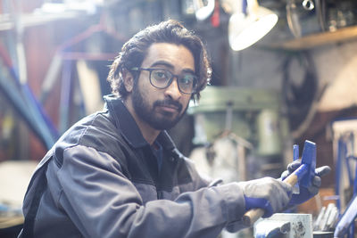 Young plumber technician working in workshop