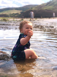 Baby sitting in rock pools