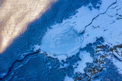 Aerial view of frozen water by trees