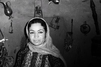 Portrait of young woman standing on floor