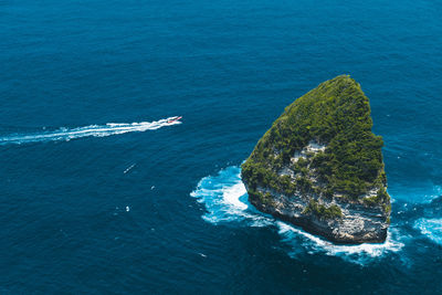 High angle view of sea by rock