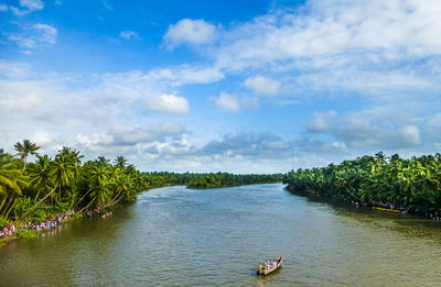 Scenic view of river against cloudy sky