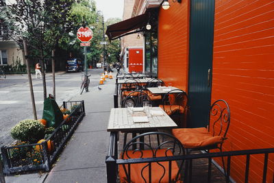 Chairs and table on street in city