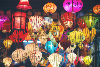 Low angle view of illuminated lanterns hanging at market stall