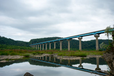 The norman wood bridge over the susquehanna river reflecting itself in a small body of water