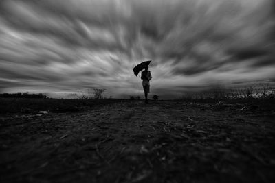 Man standing on field against sky