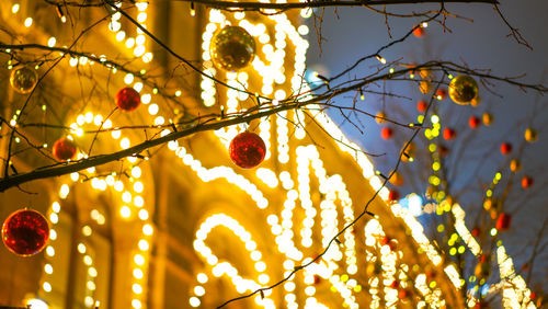Low angle view of illuminated tree against sky
