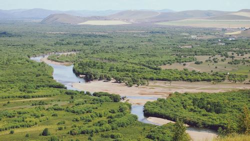 High angle view of river amidst landscape against sky