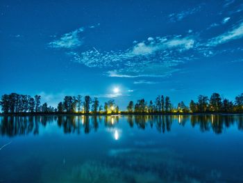 Scenic view of lake against sky at night