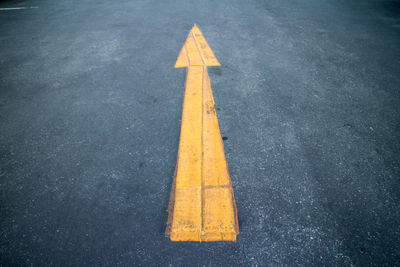 Yellow arrow symbol on road