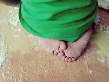 Low section of child sitting at home