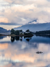 Scenic view of lake against sky at sunset