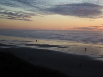 Scenic view of beach against sky during sunset