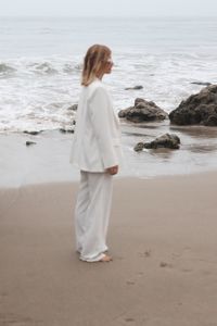 Rear view of young woman standing at beach