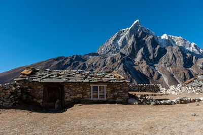 Scenic view of mountains against clear blue sky