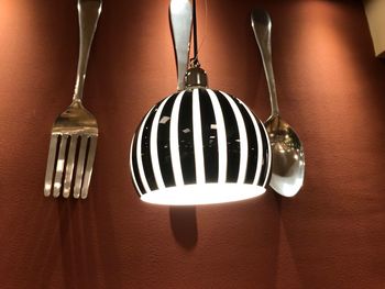 Close-up of light bulb hanging on table