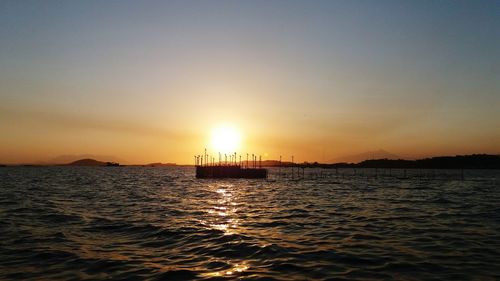 Scenic view of sea against clear sky during sunset