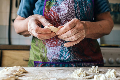 Midsection of man preparing food