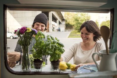 Happy male and female owners working outside food truck