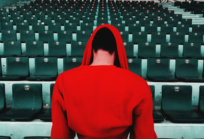 Rear view of man looking at camera