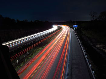 High angle view of light trails on road at night