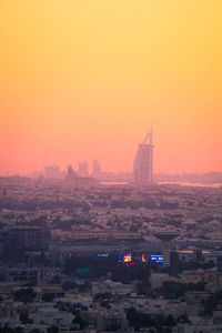 Aerial view of buildings in city during sunset