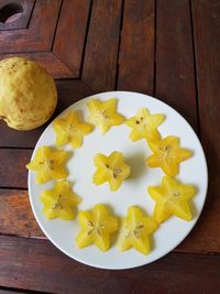 High angle view of chopped fruits in plate on table