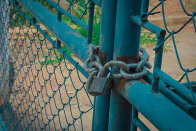Close-up of padlock on rusty metal gate