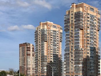 Low angle view of modern buildings in city against sky