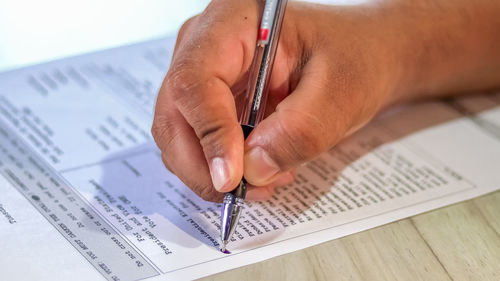 Close-up of hand holding paper