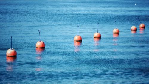 Row of buoys in sea