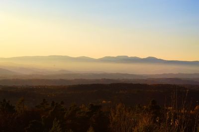 Scenic view of landscape against clear sky during sunset
