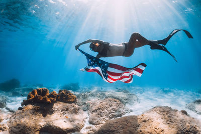 Low angle view of man jumping in sea