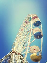 Low angle view of ferris wheel against blue sky